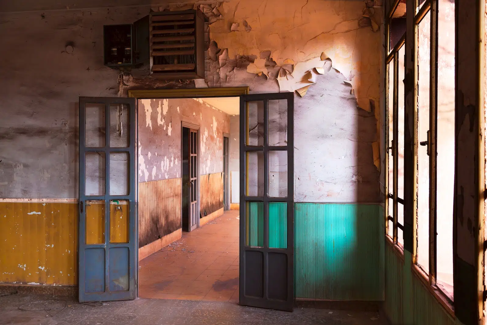 two gray wooden doors near brown painted wall